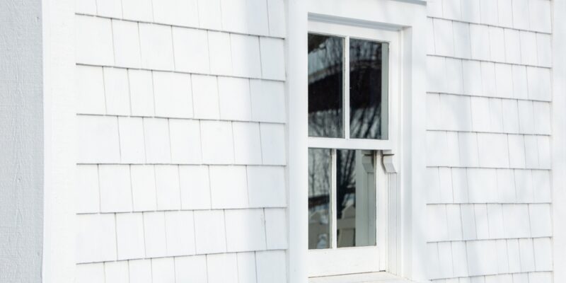single hung window on white siding of house