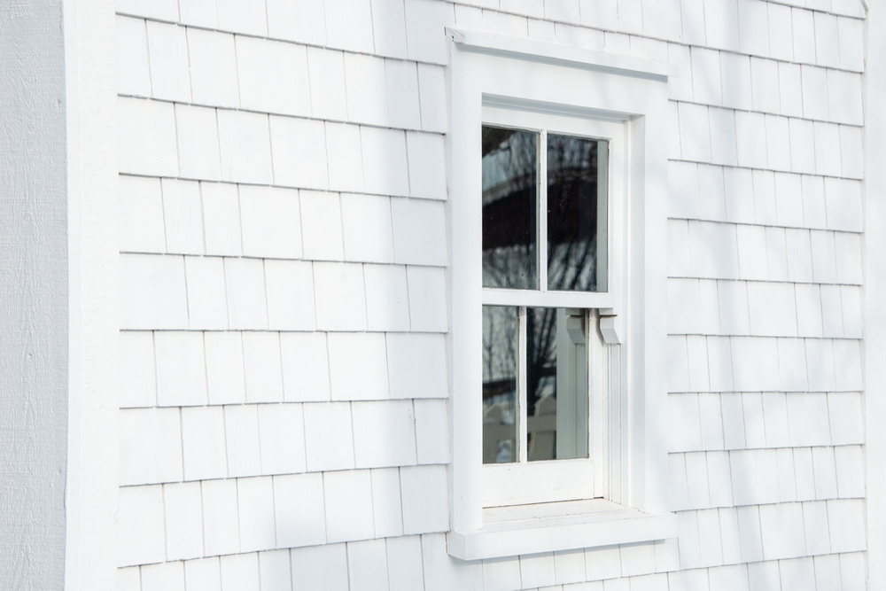single hung window on white siding of house