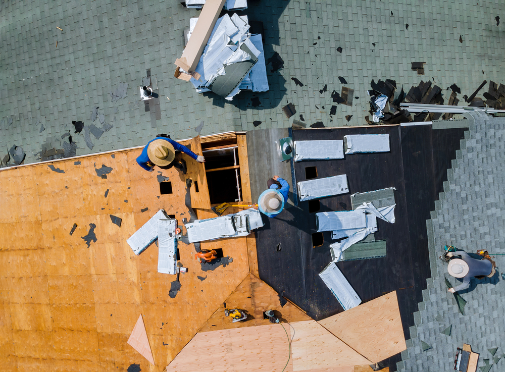 construction workers working on a new roof replacement remodeling service for a home that got inspected