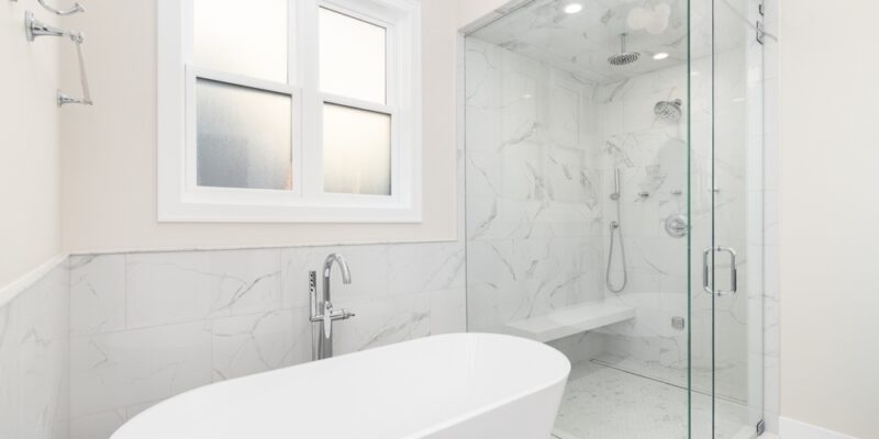 bathtub tub combination in all white master bathroom of home with walk-in shower for pros of both appliances in luxury space