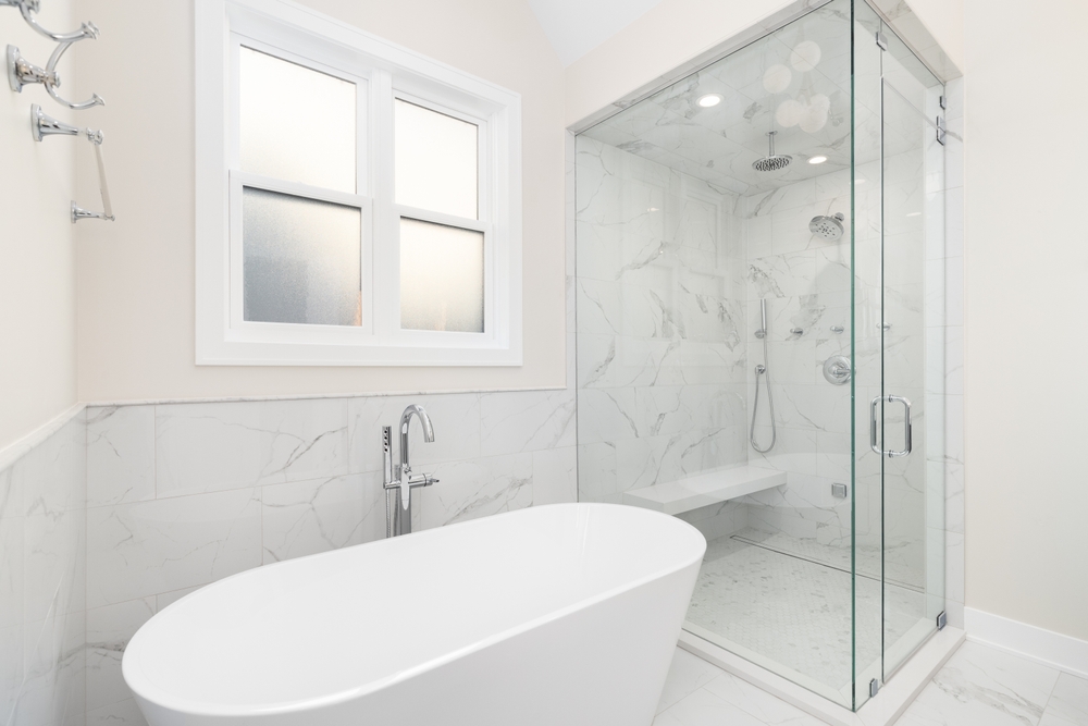 bathtub tub combination in all white master bathroom of home with walk-in shower for pros of both appliances in luxury space
