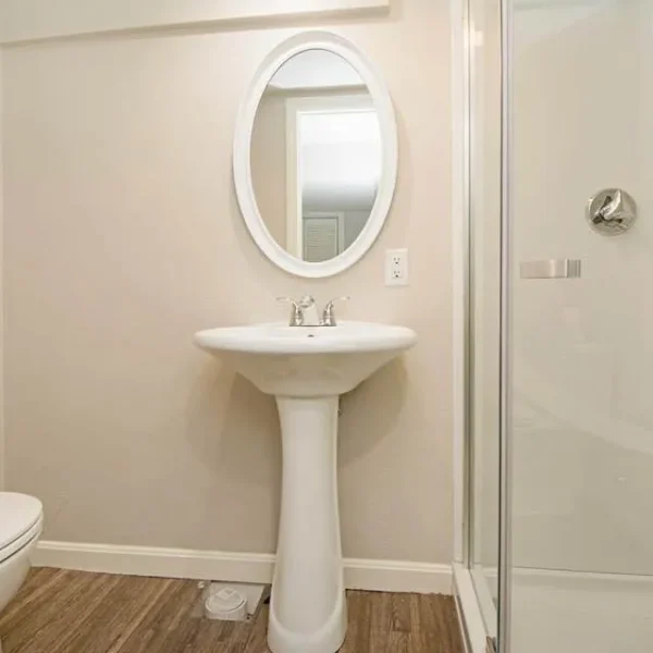 Small bathroom remodel with pedestal sink and glass shower