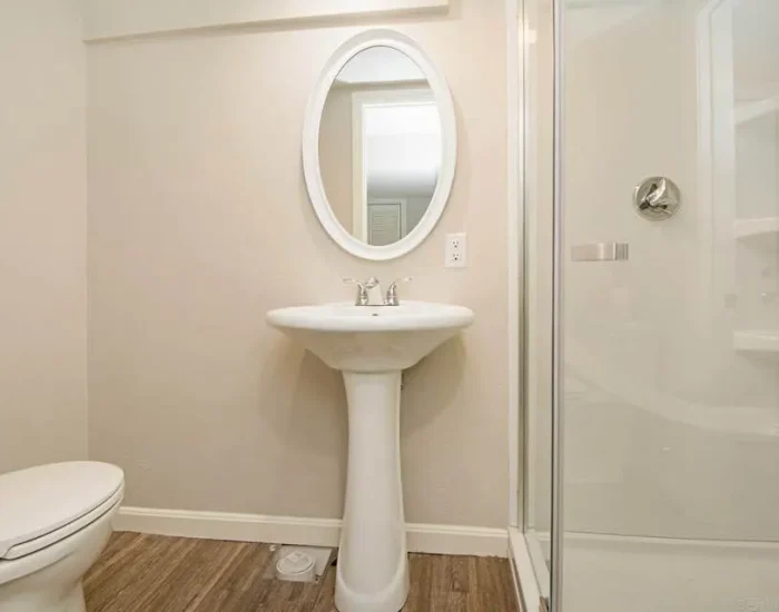 Small bathroom remodel with pedestal sink and glass shower