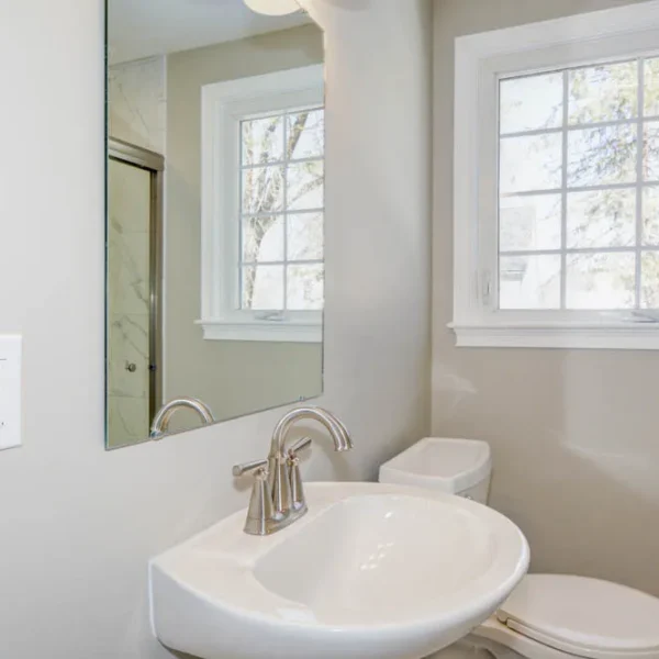 Bright bathroom remodel with pedestal sink and window