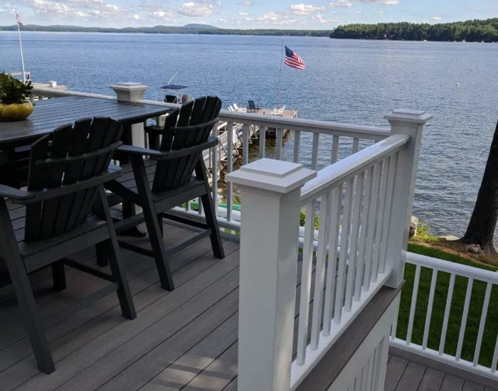 Composite deck with white railing at the lake