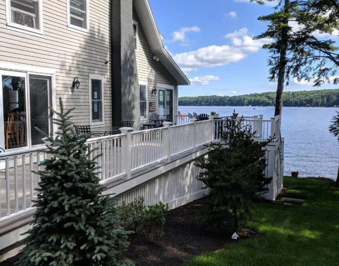 Lakeside house with white-rail deck