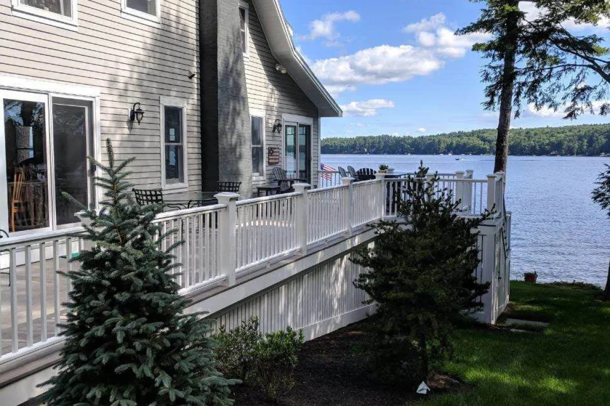 Lakeside house with white-rail deck