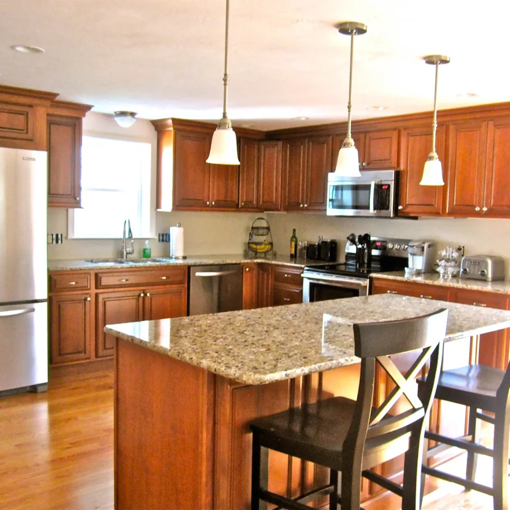 Cherry-cabinet kitchen remodel with island and stainless appliances