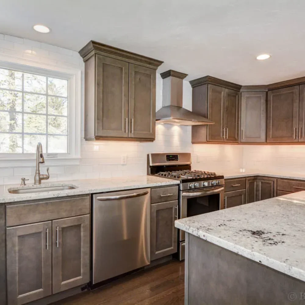 Dark-cabinet kitchen with granite counters and stainless range