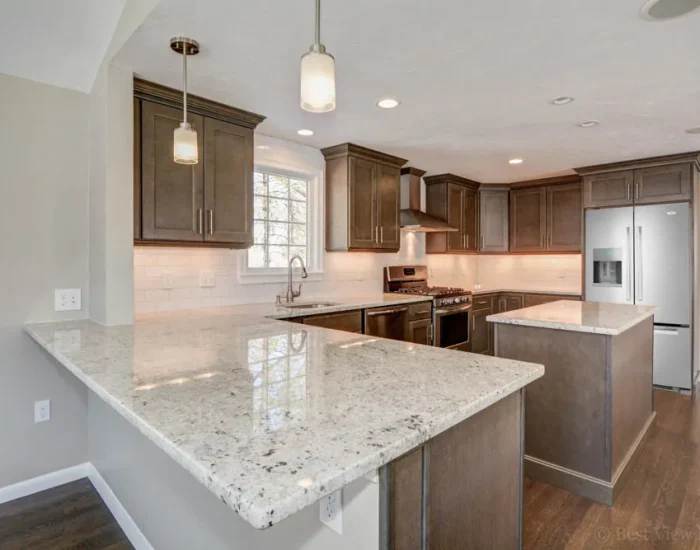 Dark-cabinet kitchen with peninsula seating and pendant lights