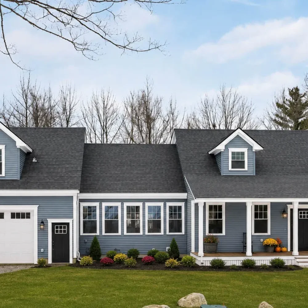 Multi-gable charcoal shingle roof on blue-gray siding home