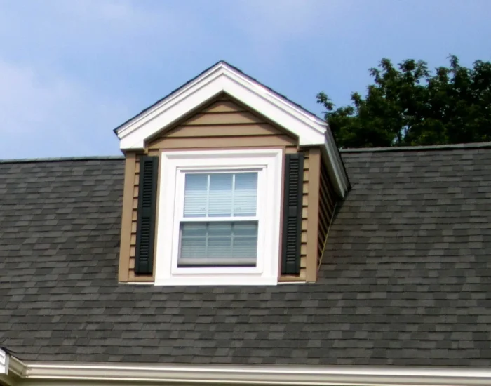 Charcoal shingle roof with dormer window and shutters